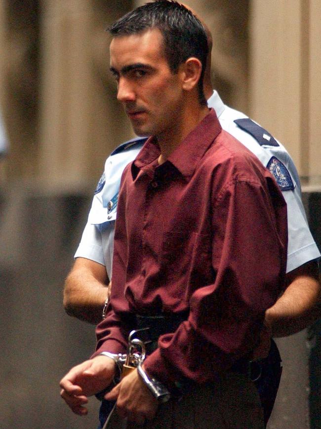 Roberts being taken to a waiting prison van in 2002 after being found guilty of the Silk-Miller murders.