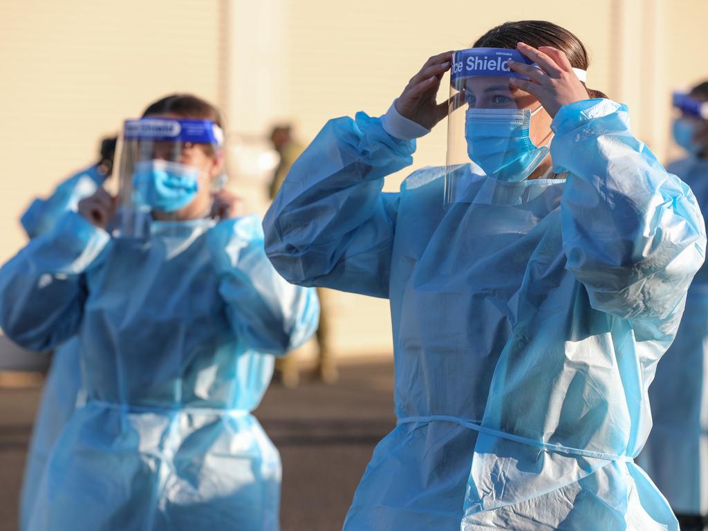 Australian Defence Force members practice correct application of PPE.