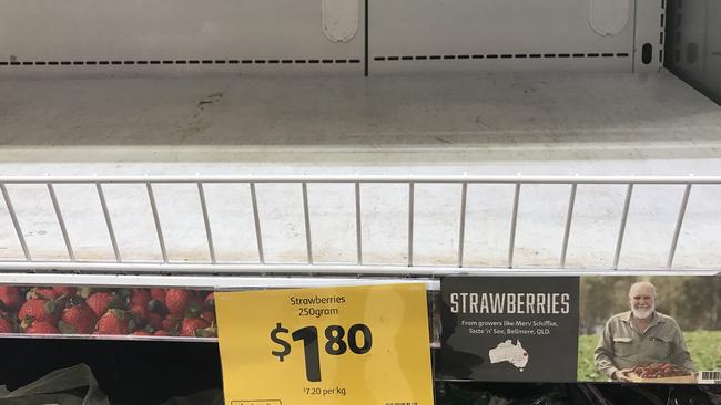 Empty shelves, normally stocked with strawberry punnets, are seen at a Coles supermarket in Brisbane in September.