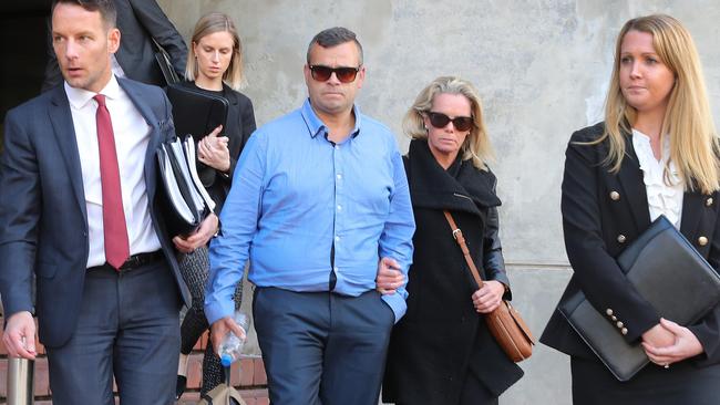 Clinton Watkins and Jenny-Lee Sullivan (together centre) with lawyers outside the Industrial Court. Picture Dean Martin