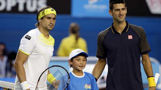 A nine-year-old McCabe was picked to toss the coin for 2013 Australian Open semi-finalists David Ferrer (left) and Novak Djokovic. Picture: Dennis Sabangan / AAP