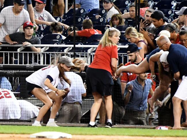 WASHINGTON, DC - JULY 17:  Fans run for cover after what was believed to be shots were heard during a baseball game between the San Diego Padres the Washington Nationals at Nationals Park on July 17, 2021 in Washington, DC.  (Photo by Mitchell Layton/Getty Images)