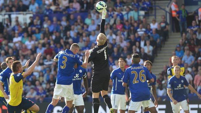 Leicester City's Danish goalkeeper Kasper Schmeichel (C) rises to make a save.