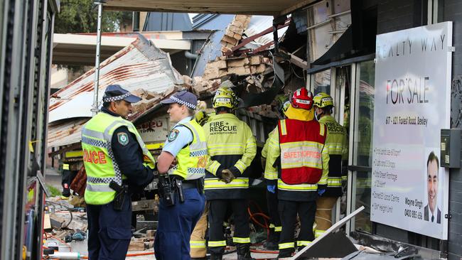 SYDNEY, AUSTRALIA - NewsWire Photos - MAY 21, 2024: A view of a truck crash in Bexley, Emergency crews, including firefighters, on the scene working hard to remove the driver who was trapped in the vehicle under rubble as the roof came down. The driver now in a stable condition taken to hospital. Picture: NewsWire / Gaye Gerard