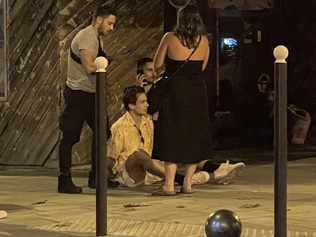 Australian mens hockey player Tom Craig sits on the footpath in Paris after being arrested for allegedly buying cocaine on Tuesday night.