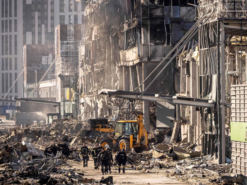 Firefighters and servicemen amid the rubble of the Retroville shopping mall in Kyiv. Picture: Fadel Senna/AFP