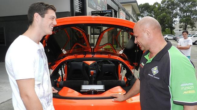 Jarrod Lawrence and Body Tech Automotive owner Peter Christodoulou talk about the features of the Toyota Sera, which Mr Christodoulou donated to Jarrod. Picture: WARREN THOMSON.