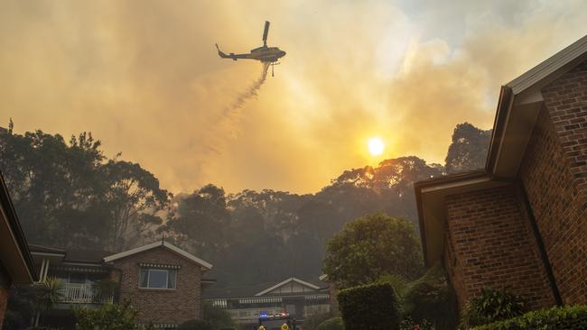 A helicopter flies over nearby homes on the Northern Beaches on Saturday. Picture: NewsWire / Jeremy Piper