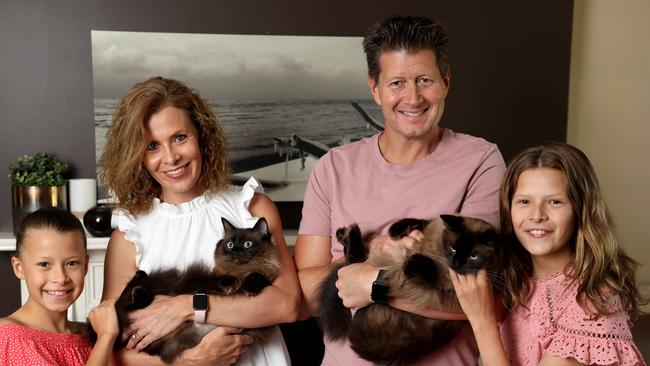 Linda and Scott Sumner with their daughters Alannah, 9, and Lily, 11, and cats Smokey and Bandit. Picture: Damian Shaw