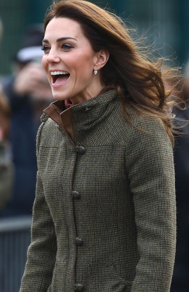 A beaming Kate Middleton arrives at the community gardens.