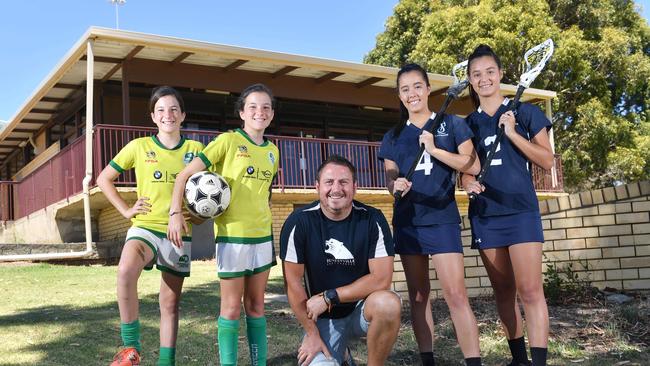 Cumberland Woman's Soccer Club players Makenzie, 12, Cadence, 12, Paul Blenkiron, Sturt Lacrosse Club players Anastasia, 17, and Makayla, 15, at the Women's Memorial playing Fields. Picture: AAP/ Keryn Stevens