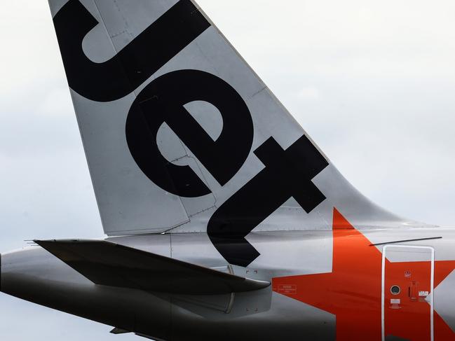 SYDNEY, AUSTRALIA - JANUARY 20: The Jetstar logo displayed on an aircraft tail at Sydney Airport  on January 20, 2024 in Sydney, Australia. Transport Minister Catherine King signed off on a deal that will allow Turkish Airlines to start serving the Australian market, rising to 35 flights a week by 2025. The decision came as the government was under mounting criticism from many for a perception that it was protecting the profits of Qantas and stymying competition in the market by limiting additional capacity for other carriers, such as Qatar Airways. (Photo by Jenny Evans/Getty Images)
