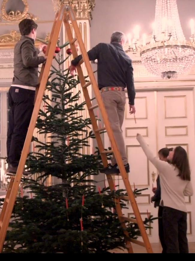 the Danish palace released a festive video showing the smiling couple decorating a giant tree with their four children.