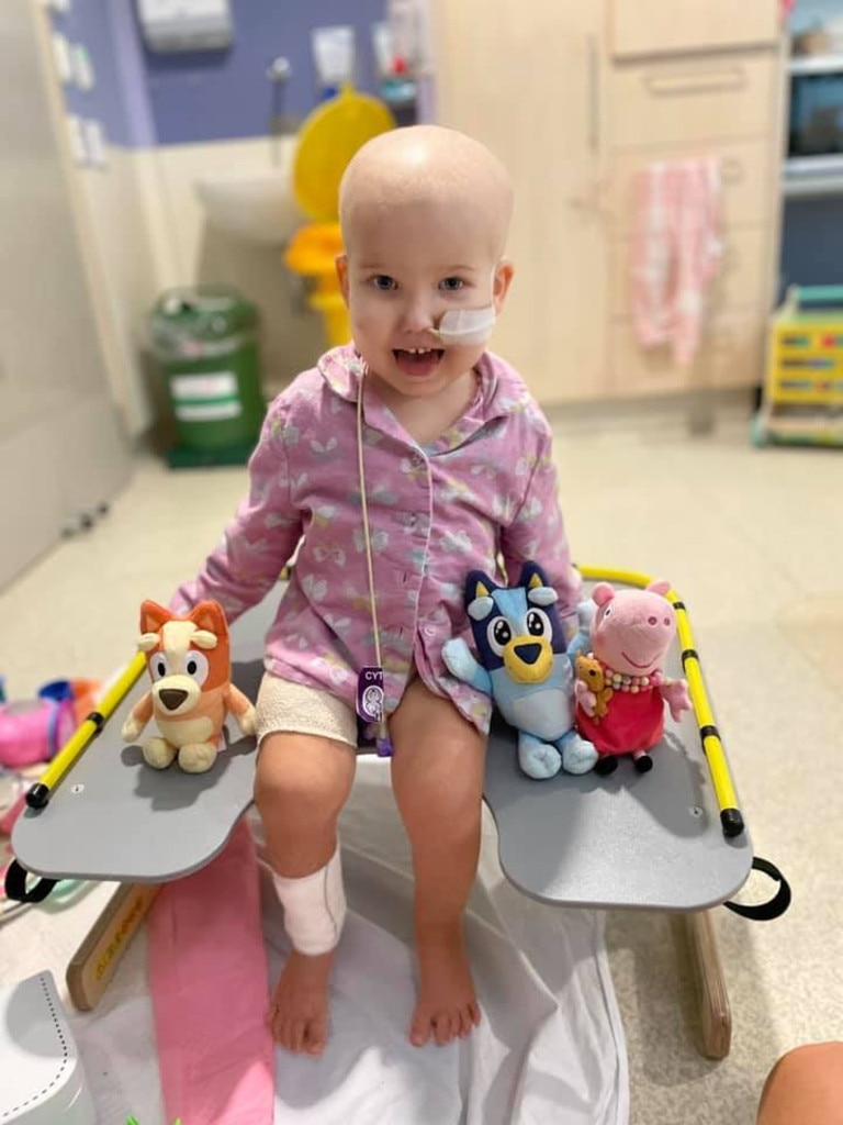 Ellie Ross in hospital, surrounded by toys.