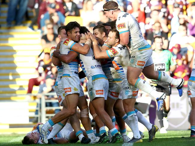 The Titans celebrate a try during yesterday’s 26-18 win over the Broncos. Picture: Jono Searle/Getty Images