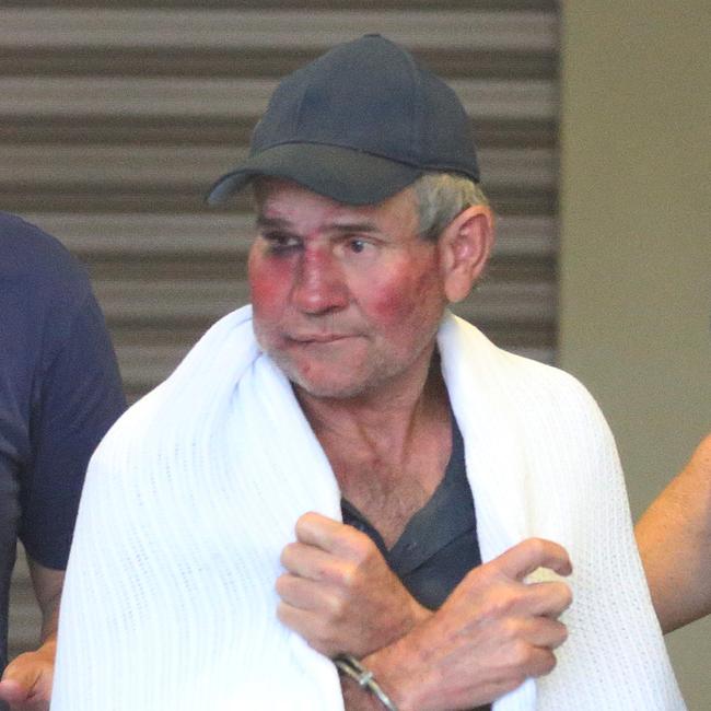 Gino Stocco is escorted by two policemen as he is taken into Dubbo police station after he and his son Mark were arrested earlier in the day in Dunedoo in north west NSW. Wednesday, Oct. 28, 2015. (AAP Image/David Moir)