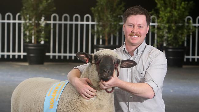 Ryan Bechaz and his supreme champion Hampshire Down ram. Picture: Yuri Kouzmin