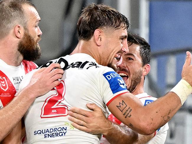 GOLD COAST, AUSTRALIA - MARCH 09: Zac Lomax of the Dragons is congratulated by team mates after scoring a try during the round one NRL match between the Gold Coast Titans and St George Illawarra Dragons at Cbus Super Stadium, on March 09, 2024, in Gold Coast, Australia. (Photo by Bradley Kanaris/Getty Images)