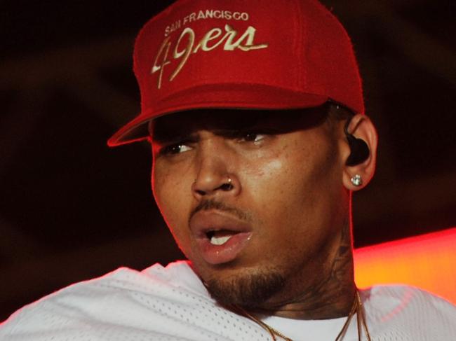 (FILES) This file photo taken on June 26, 2015 shows singer Chris Brown performing during a free concert in Champ de Mars, downtown Port-au-Prince, Haiti.  A Los Angeles woman filed a lawsuit on Wednesday, May 9, 2018 against Chris Brown and a fellow rapper, alleging she was repeatedly raped and sexually assaulted at Brown's home during a drug- and alcohol-fueled party last year. The woman, identified only as Jane Doe, said she was lured to the singer's house following a concert at a nightclub on February 23, 2017 and was raped several times by Lowell Grissom, who performs under the name Young Lo.  / AFP PHOTO / Hector RETAMAL