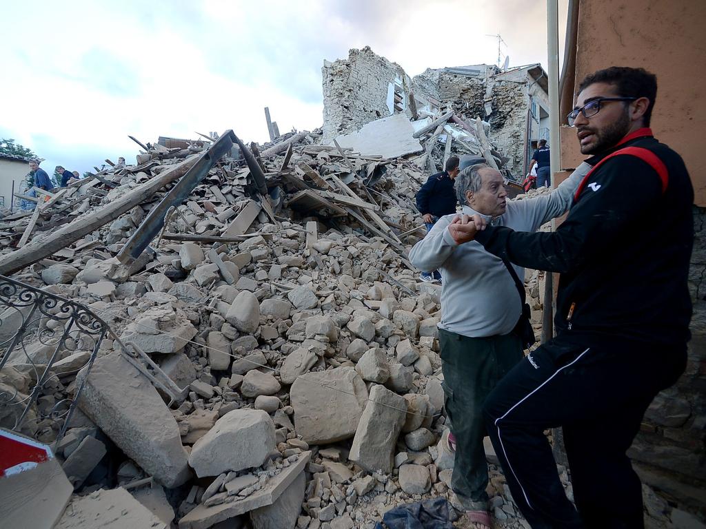 A resident stands among damaged buildings after a strong earthquake hit Amatrice on August 24, 2016. Picture: AFP