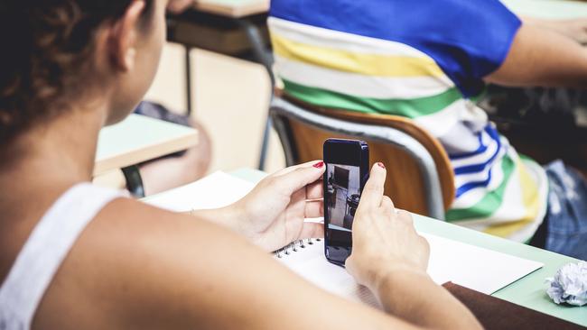 Students try to look engaged while simultaneously checking their phones.