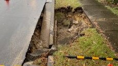 A burst water main has caused a massive hole to emerge on the edge of Warringah Rd, Narraweena on Tuesday morning. Picture: Sydney Water.