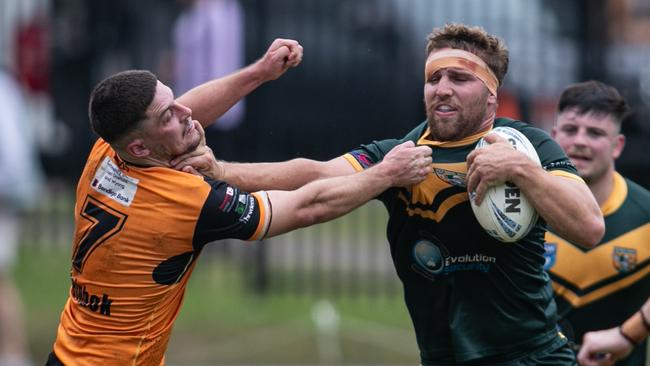 Blake Andrews palming off Jack Burraston. Picture: Julian Andrews