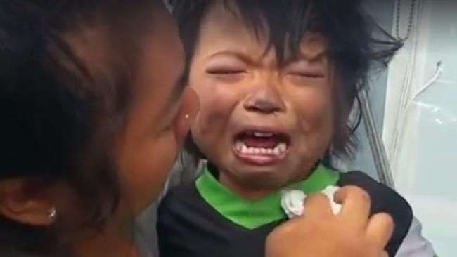 A woman consoles a child after the terrifying incident.