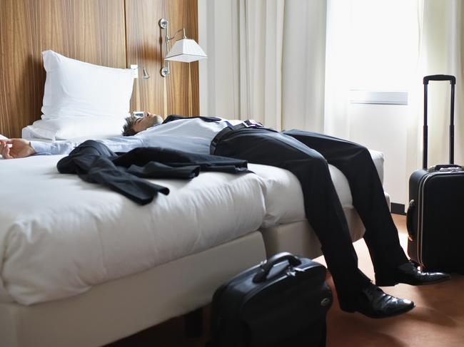 Businessman Sleeping in Motel Room