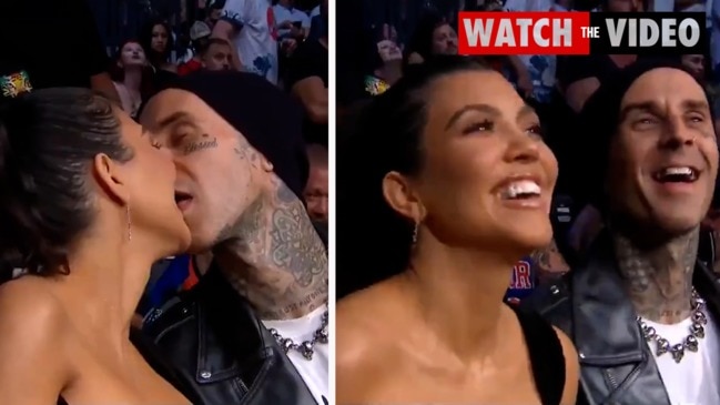 Kourtney and Travis share an on-screen kiss at a Las Vegas UFC match