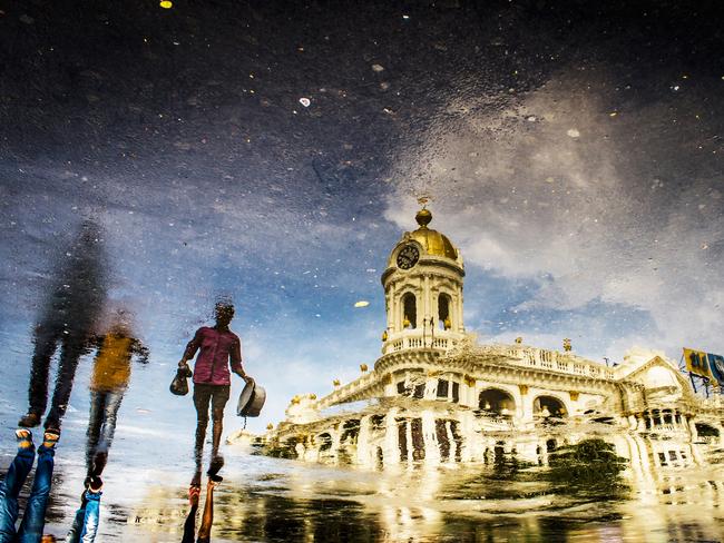 Reflection. Photographer: Ranajit Chatterjee Year: 2018 “This photograph was taken in Kolkata, in front of a British architectural building (at present it is known as LIC Building).There was an unexpected rain shower and I was lucky enough to capture the reflection.” Copyright: © Ranajit Chatterjee, India, Entry, Open, Street Photography, 2018 Sony World Photography Awards