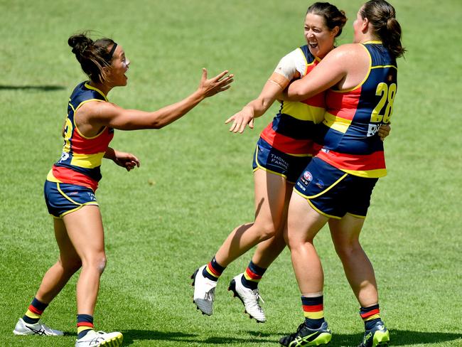 Crows midfielder Justine Mules celebrates a goal with her teammates Renee Forth and Sarah Perkins in their win over Geelong on February 17. Photo: AAP Image/Sam Wundke