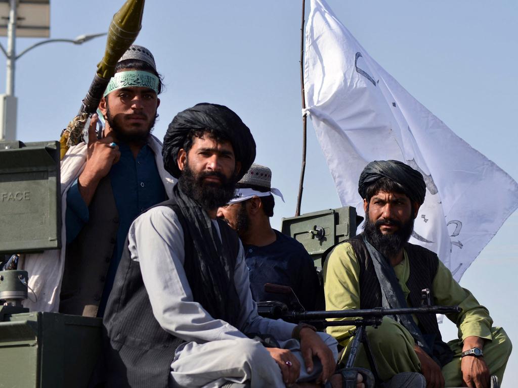 Taliban fighters stand on an armoured vehicle parade in Kandahar. Picture: JAVED TANVEER / AFP