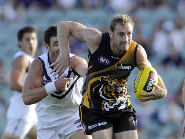 AFL NAB CUP - Fremantle Dockers v Richmond Tigers at Patersons Stadium, Perth. PICTURED- Richmond's Shane Tuck shrugs the tackle from Docker Ryan Crowley.