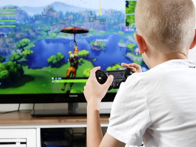 Cooper Thompson posing at his Capalaba home, Brisbane 11th of August 2018.  Cooper is playing the game Fortnite on a PS4.  (AAP Image/Josh Woning)