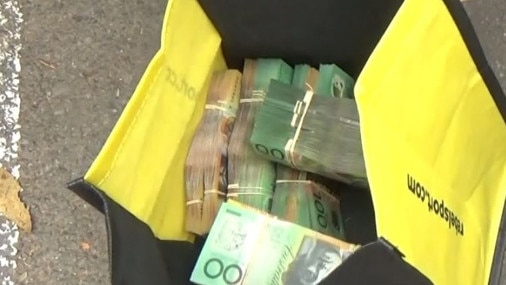 Bags of cash seized after the alleged sale of illegal cigarettes. Picture: NSW Police