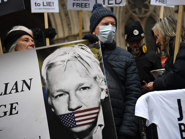 Supporters of WikiLeaks founder Julian Assange protest against his extradition to the US outside the High Court in London. Picture: AFP.