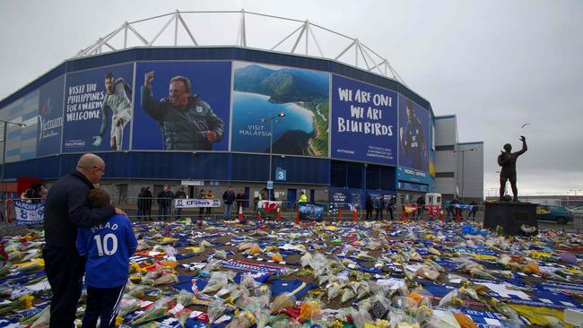 A display of Cardiff City scarfs, jerseys, flowers, messages and other tributes to Sala outside the ground.