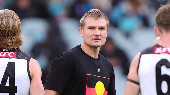 ADELAIDE, AUSTRALIA - MAY 19: Ollie Wines of the Power who was subbed out during the 1st quarter with walks out at to team mates at the half time break during the 2024 AFL Round 10 match between Yartapuulti (Port Adelaide Power) and the Hawthorn Hawks at Adelaide Oval on May 19, 2024 in Adelaide, Australia. (Photo by Sarah Reed/AFL Photos via Getty Images)