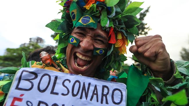 A supporter of far-right president-elect Jair Bolsonaro celebrates in Rio de Janeiro yesterday. Picture: Getty Images