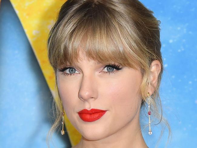 (FILES) In this file photo taken on December 16, 2019 US singer Taylor Swift arrives for Universal Pictures' world premiere of "Cats" at Alice Tully Hall on December 16, 2019 in New York City. - Taylor Swift dropped her directorial debut on February 27, 2020, releasing the music video for her song "The Man" in which she stars as, quite literally, the man. In heavy prosthetics and convincing drag, the 30-year-old pop juggernaut parades through the video as an obnoxious man who skates through life to success thanks to the privilege of his gender. (Photo by Angela Weiss / AFP)