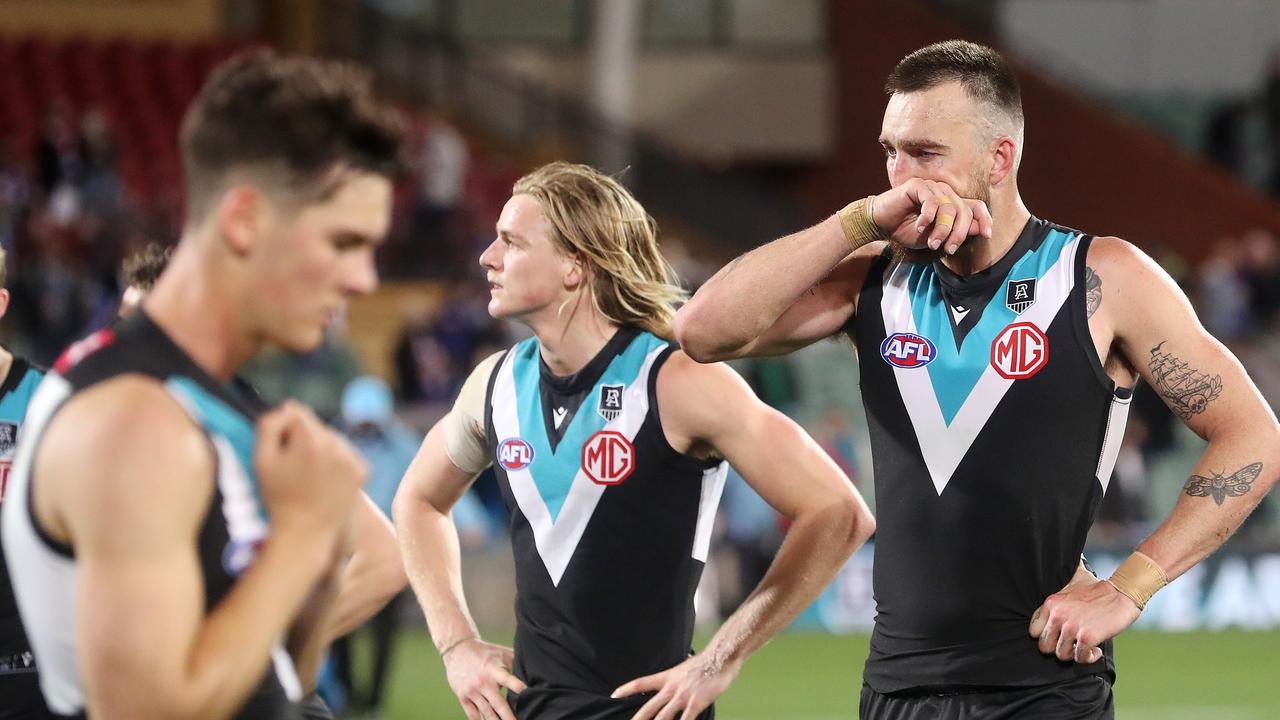 Connor Rozee, Miles Bergman and Charlie Dixon after the final siren. Picture: Sarah Reed/AFL Photos