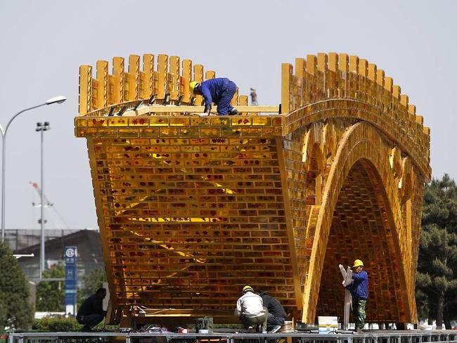 Workers install the ‘Golden Bridge of Silk Road’ outside a summit showcasing President Xi Jinping's signature foreign-policy plan ‘One Belt, One Road’. Picture: AP