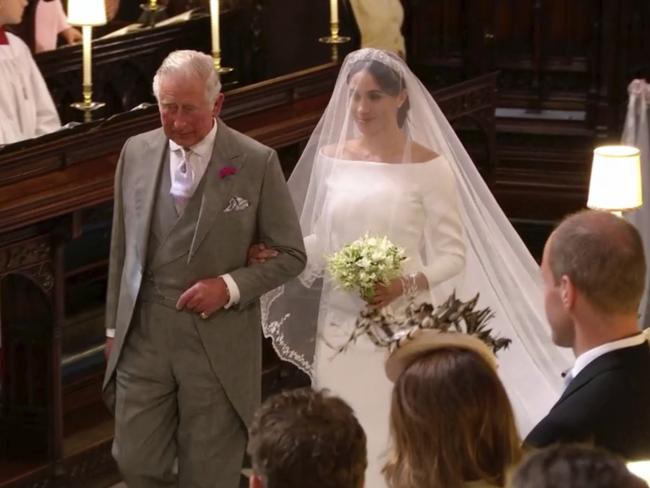 Meghan Markle walks down the aisle with Prince Charles for her wedding. Picture: Pool/Sky News via AP