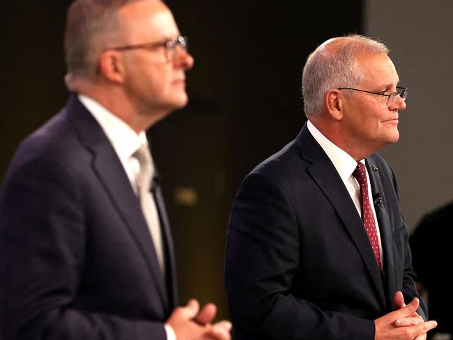 Australian Prime Minister Scott Morrison (R) and the leader of the opposition, Anthony Albanese, attend the first leaders' debate of the 2022 federal election campaign at the Gabba in Brisbane on April 20, 2022. (Photo by Jason Edwards / various sources / AFP)