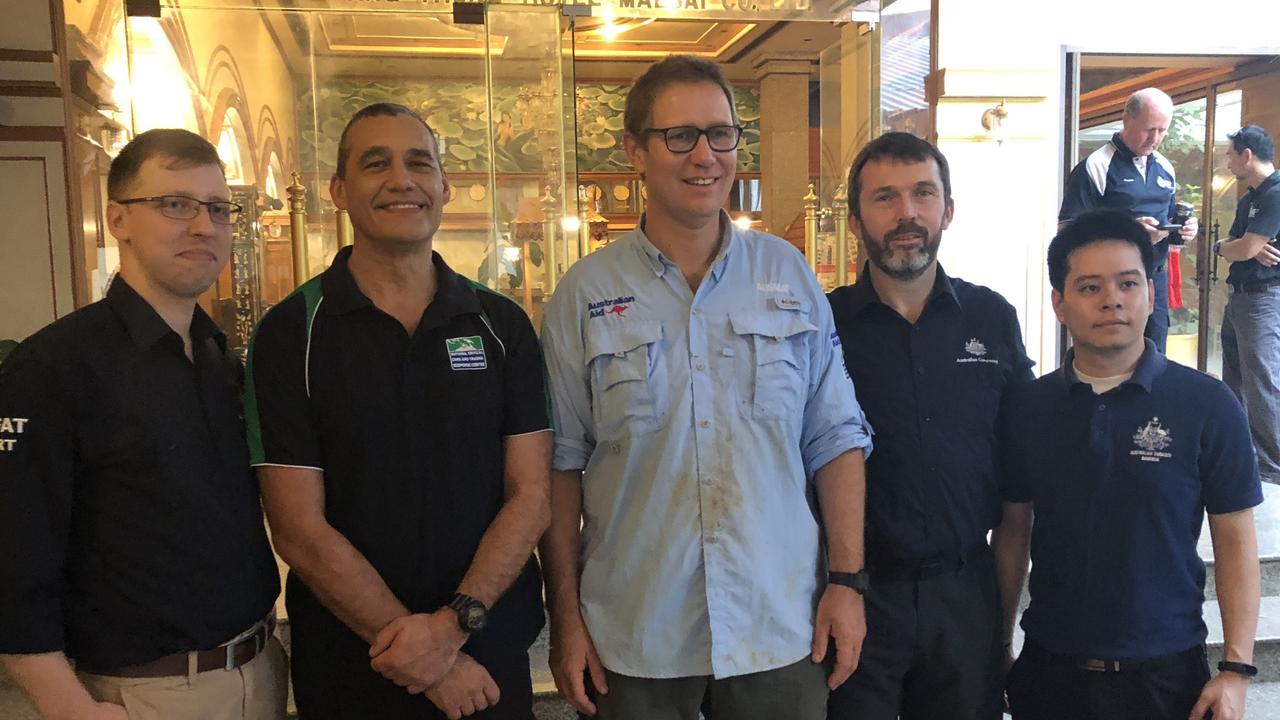 11/07/2018: Australian DFAT staff celebrate with Doctor Richard Harris (in light blue) and his dive buddy Craig Challen (next to him on the left) after they contributed the successful rescue of 12 soccer players and their coach from a cave in Thailand.