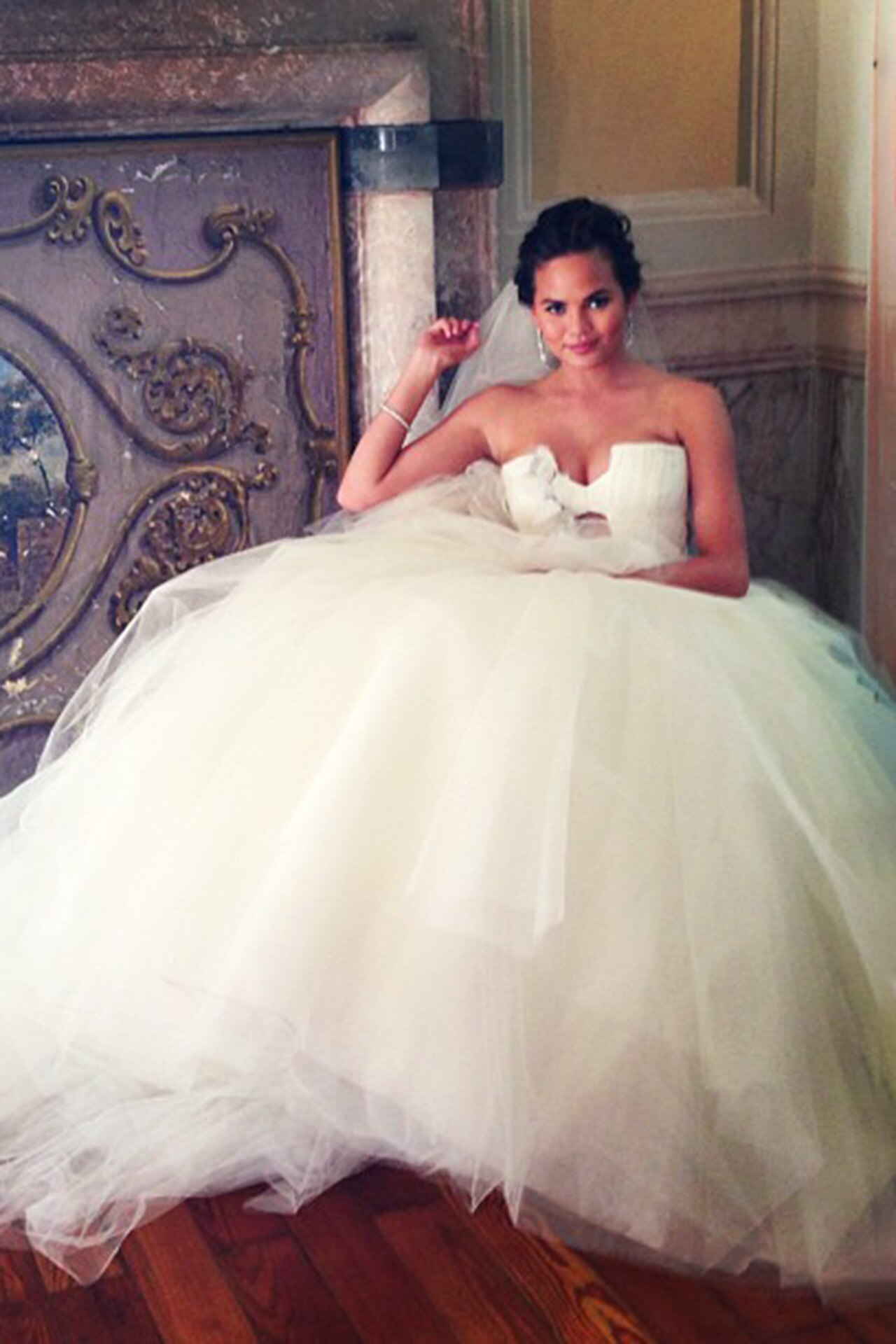 <p><em>Image credits: Instagram.com/chrissyteigen</em></p><h2>Chrissy Teigen in Vera Wang</h2><p>In 2013, Chrissy Teigen and John Legend chose a destination wedding in stunning Lake Como, Italy, exchanging vows in front of the Italian lakeside. Teigen wore a voluptuous Vera Wang strapless gown with a sweetheart neckline and billowing tulle skirt to the ceremony. Later she drew inspiration from Wang&rsquo;s fall 2012 collection, taking a more bridal approach and opting white a white version of the strapless number. Her reception called for a more colourful affair, with her third Vera Wang dress drenched in a deep red colour.</p>