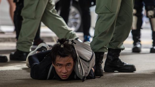 Riot police detain a man as they clear protesters taking part in a rally against a new national security law in Hong Kong on July 1, 2020, on the 23rd anniversary of the city's handover from Britain to China Picture: AFP