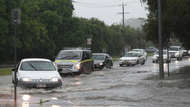 Cars make their way through rising waters on the southern end of the Gold Coast. Picture: Mike Batterham