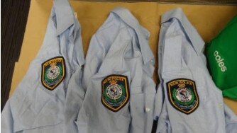 three blue NSW Police button up shirts were found in the house.